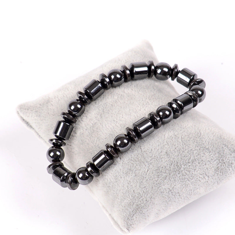 Black beaded bracelet on a white surface