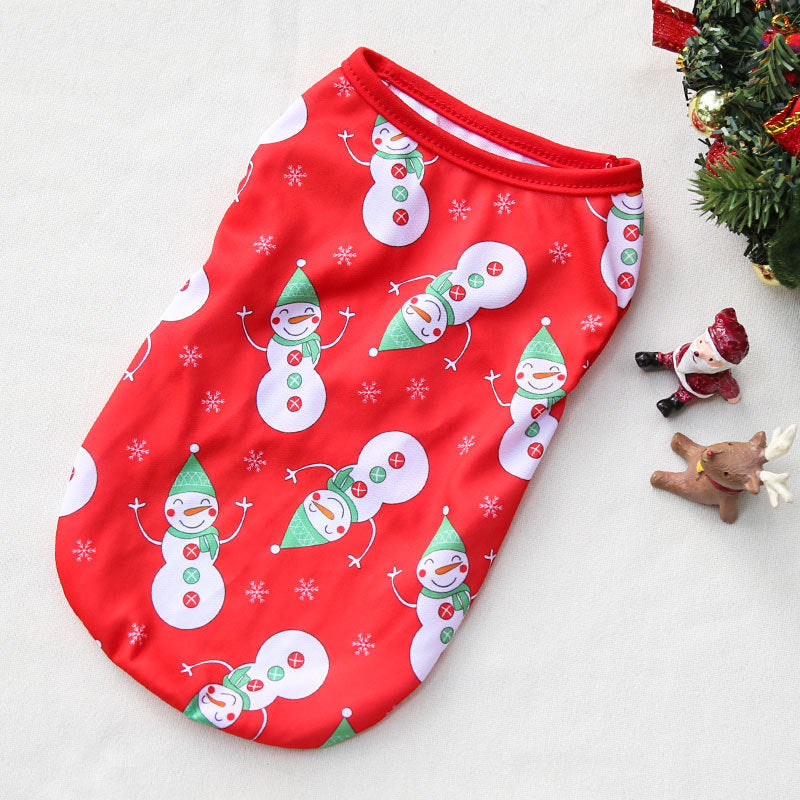 Red baby romper with snowman pattern on a white surface with Christmas decorations.