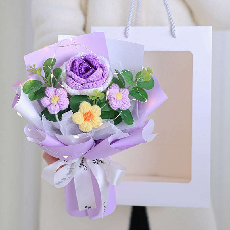 Bouquet of purple and pink flowers with green leaves on a white background