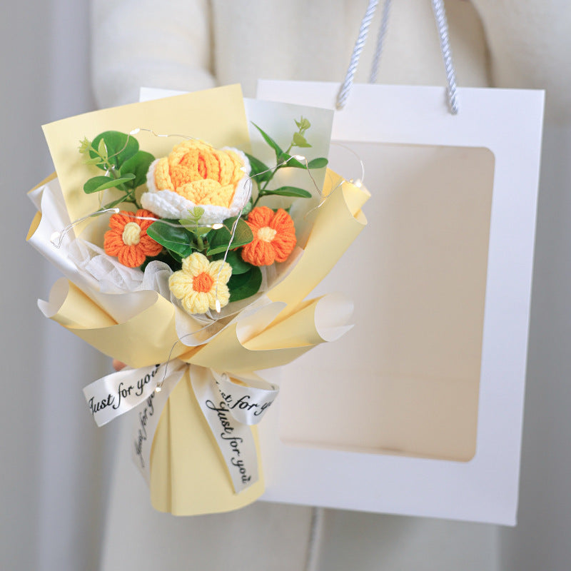 Bouquet of yellow and orange flowers with a white card on a light gray background