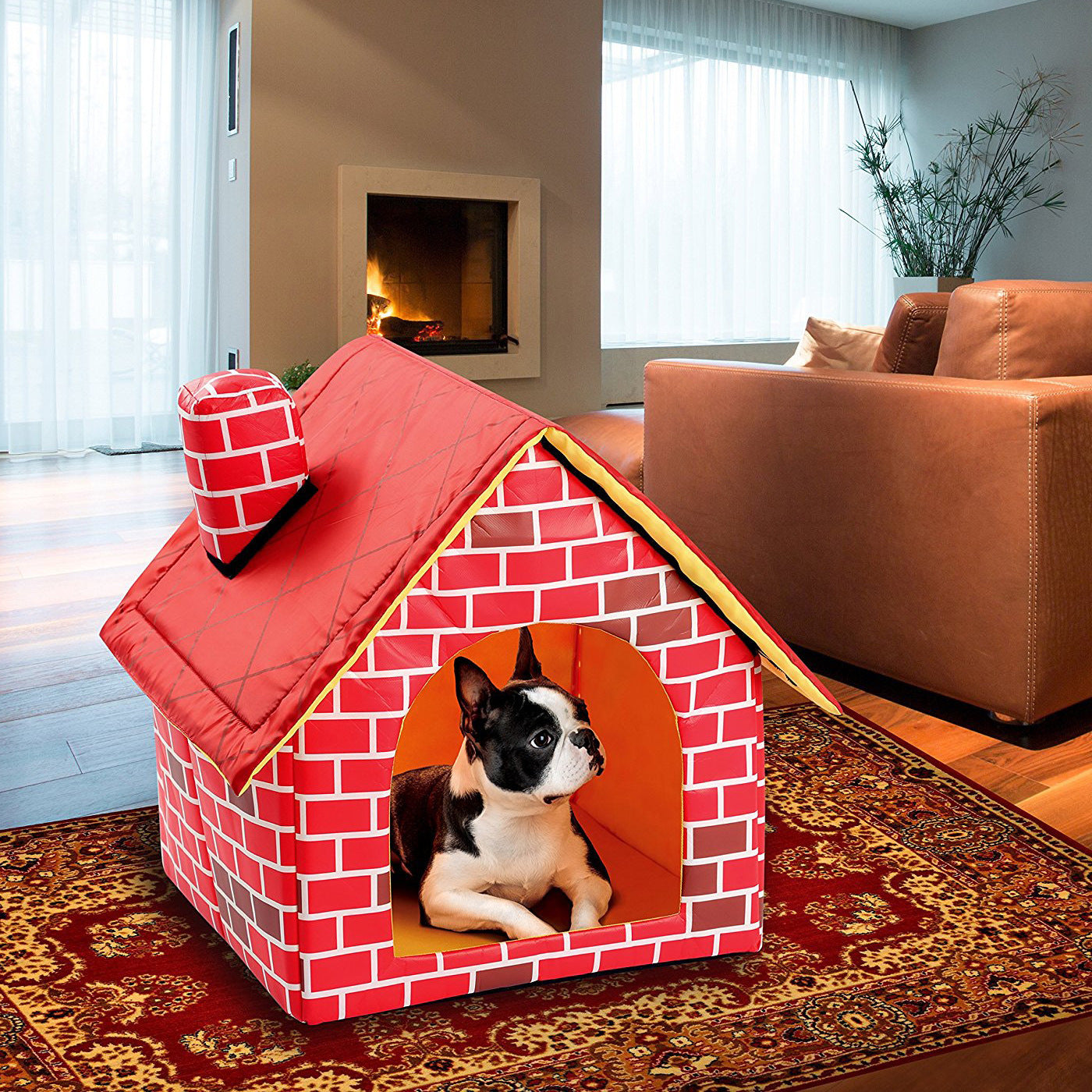 Dog lying inside a red brick-style pet house in a living room.