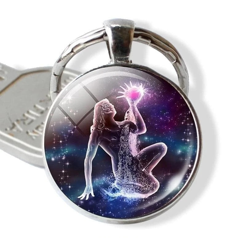 Keychain with a design of a woman holding a star against a cosmic background, branded 'Zodiac Jewelry'.