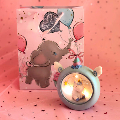 Decorative lamp with unicorn and elephant design on a pink background