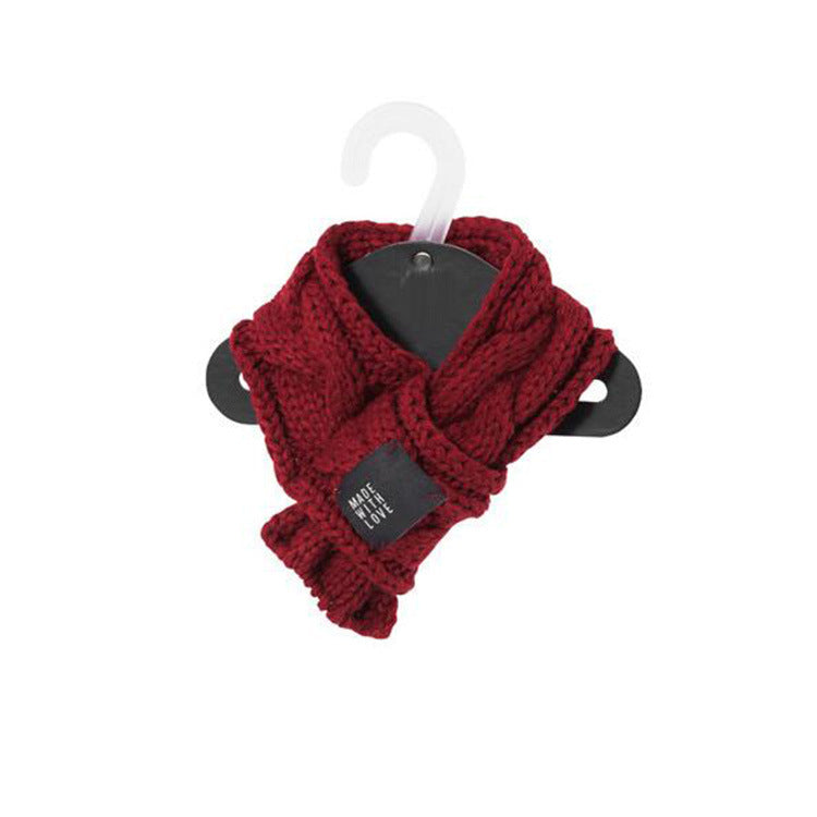 Red knitted scarf on a hanger with a tag against a white background