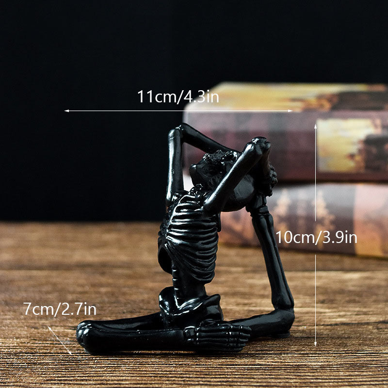Skeletal yoga pose figurine with measurements on a wooden surface